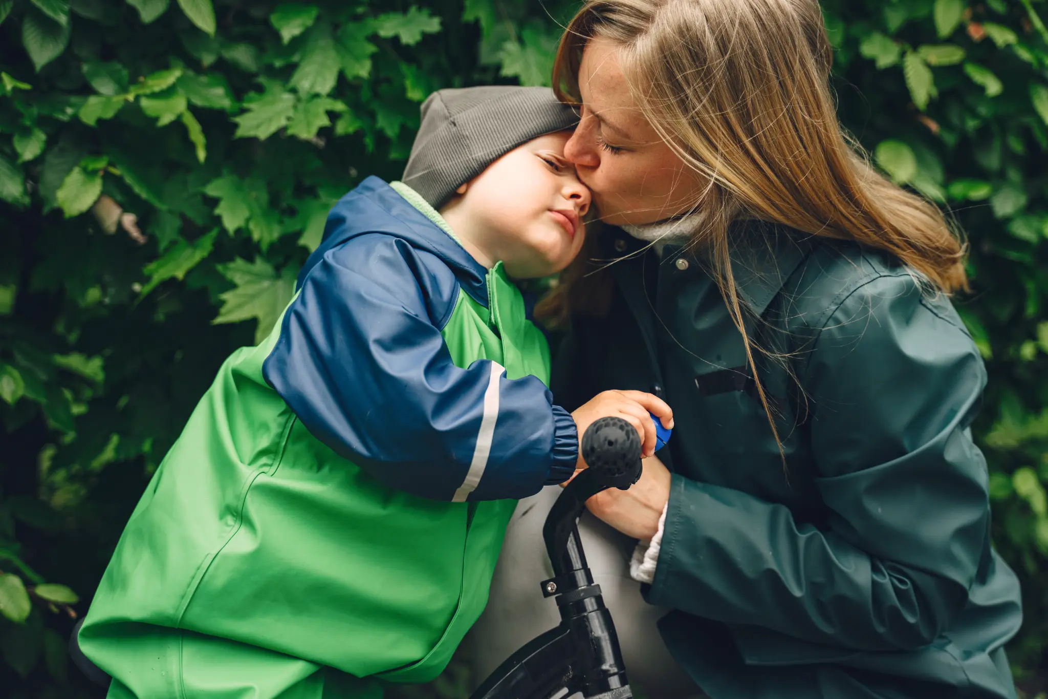 Mother and child enjoying the garden in the rain