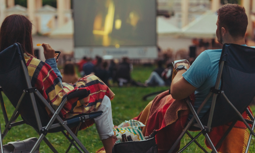 Couple enjoying outdoor cinema in the park