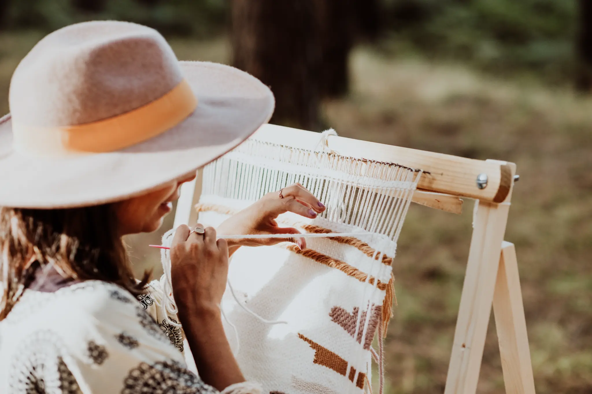 Woman weaving on a loom outdoors