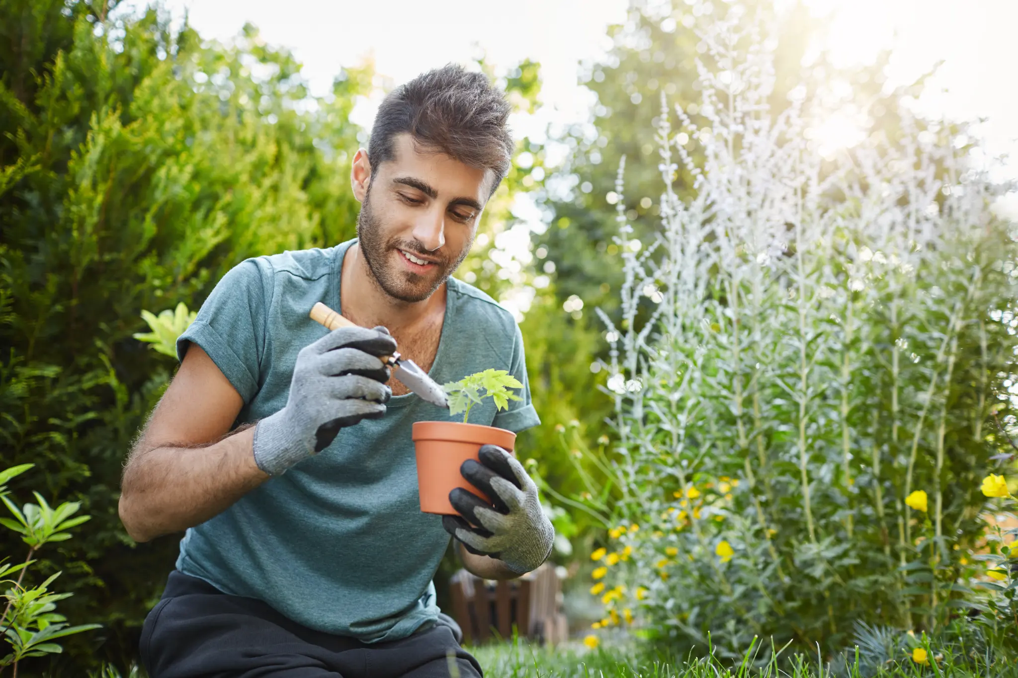 Young man peacefully tending to plants